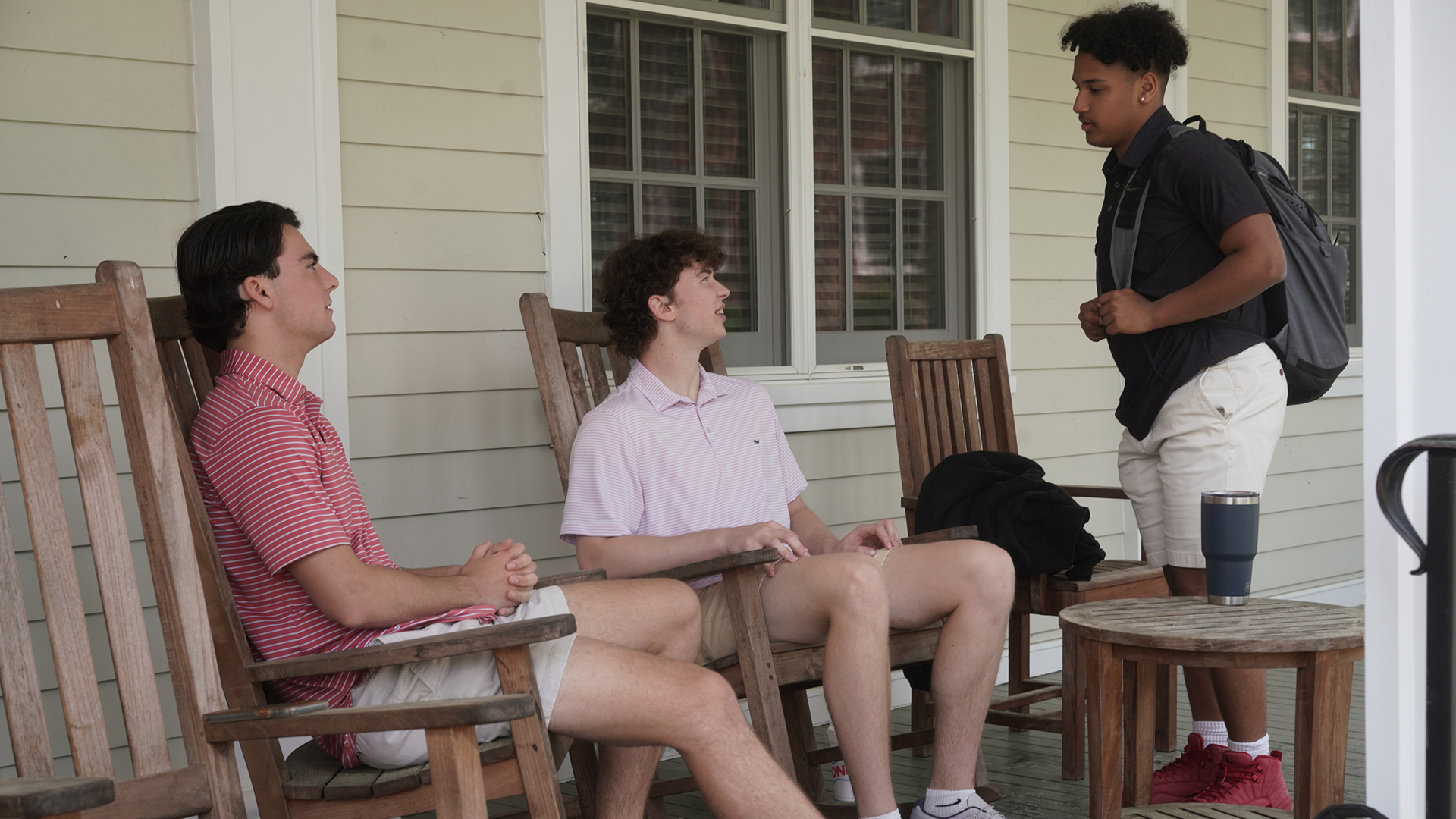 students talking on a porch