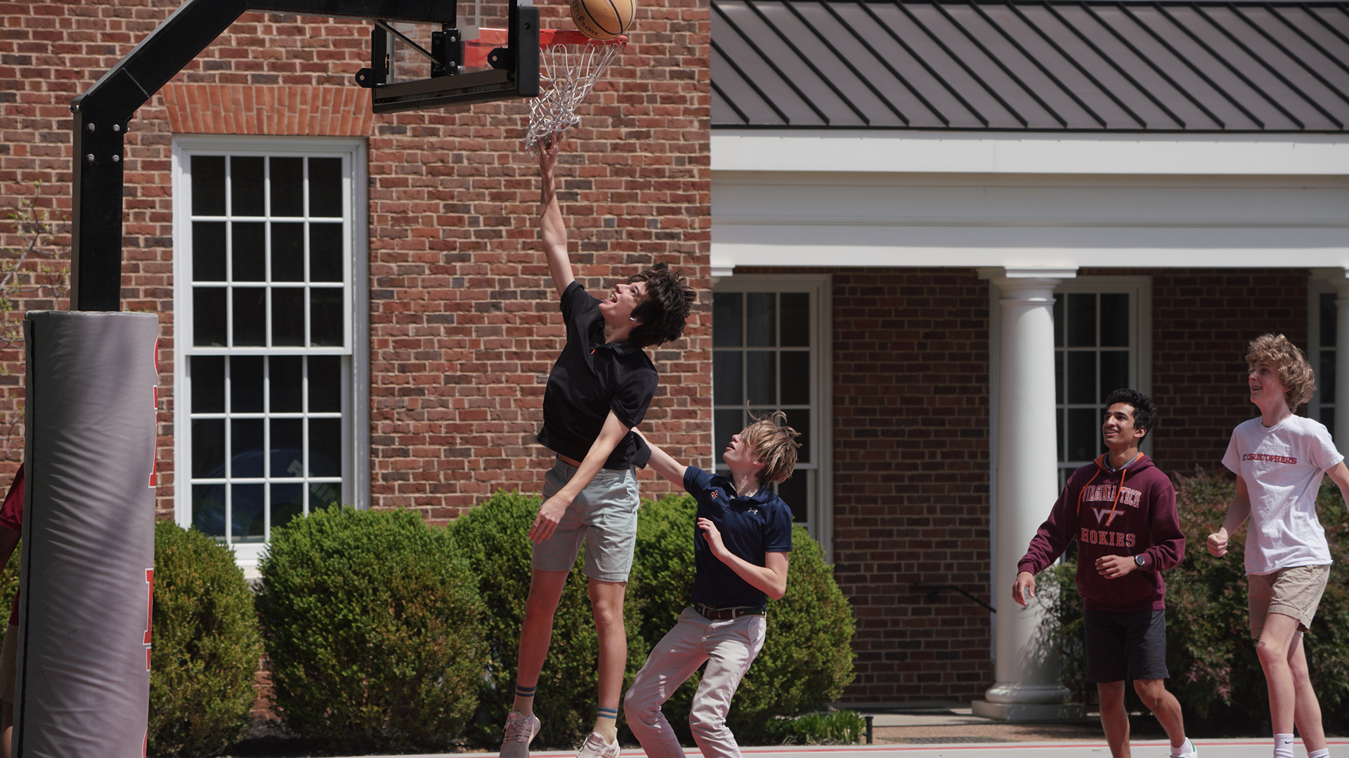 students playing basketball on campus