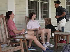 students talking on a porch