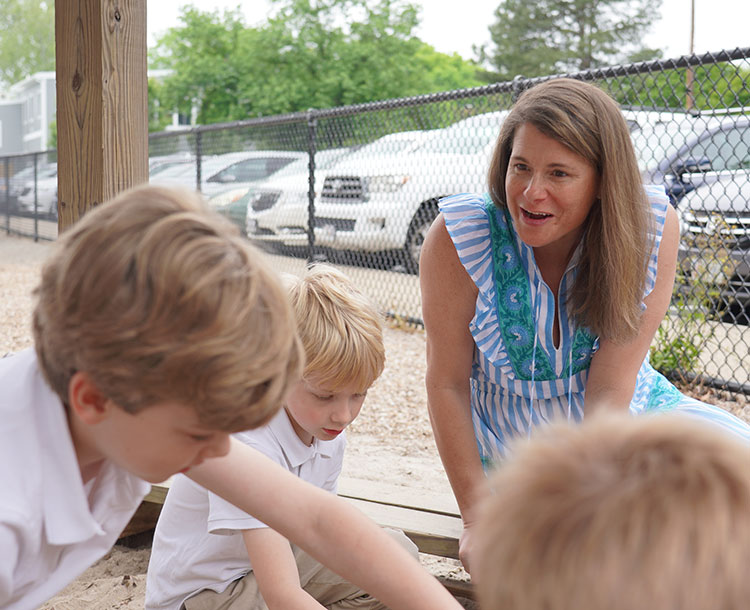 teacher with young students in the playground
